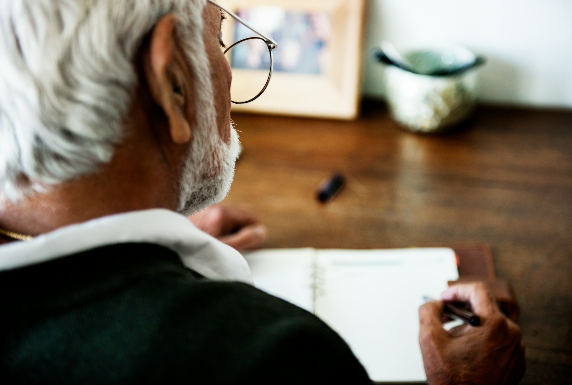 A man at a desk writing a letter